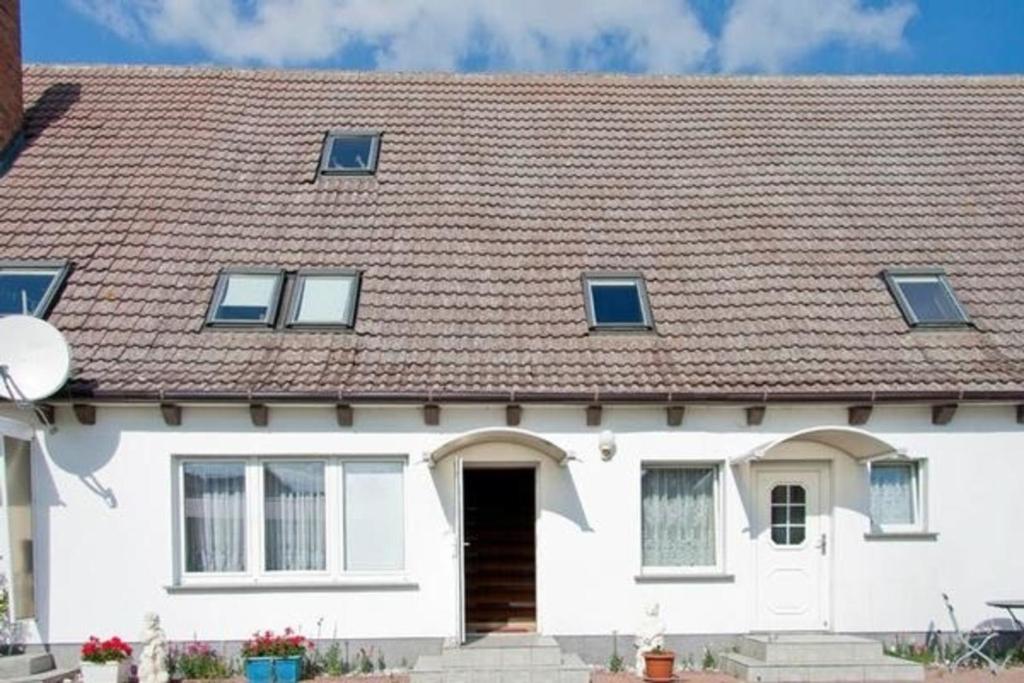 KrumminFerienwohnung für 4 Personen ca 70 qm in Krummin, Ostseeküste Deutschland Usedom的白色房子,有棕色的屋顶