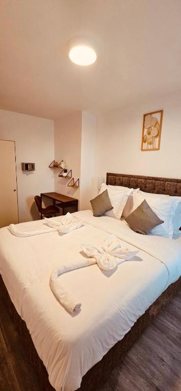 巴黎HOTEL FORMIO的一间卧室配有一张白色大床,床上有鲜花
