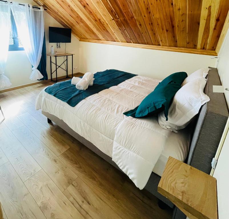 萨拉济Au sommet des Salazes的一间卧室设有一张带木制天花板的大床