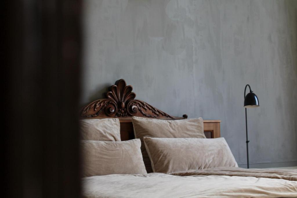 米德尔堡Logies aan de Dam的一间卧室配有一张带白色床单和一盏灯的床。