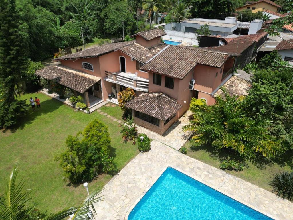 卡拉瓜塔图巴Recanto da Rose Guesthouse的享有带游泳池的房屋的空中景致