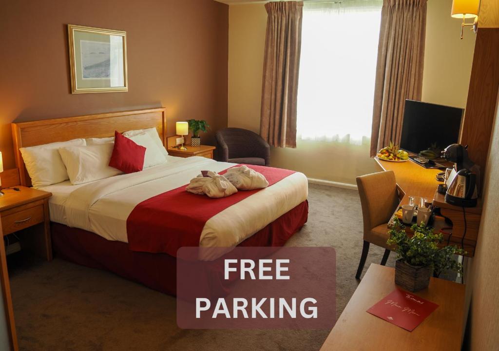 卡迪夫加的夫湾未来旅馆的酒店客房,配有一张带免费停车标志的床