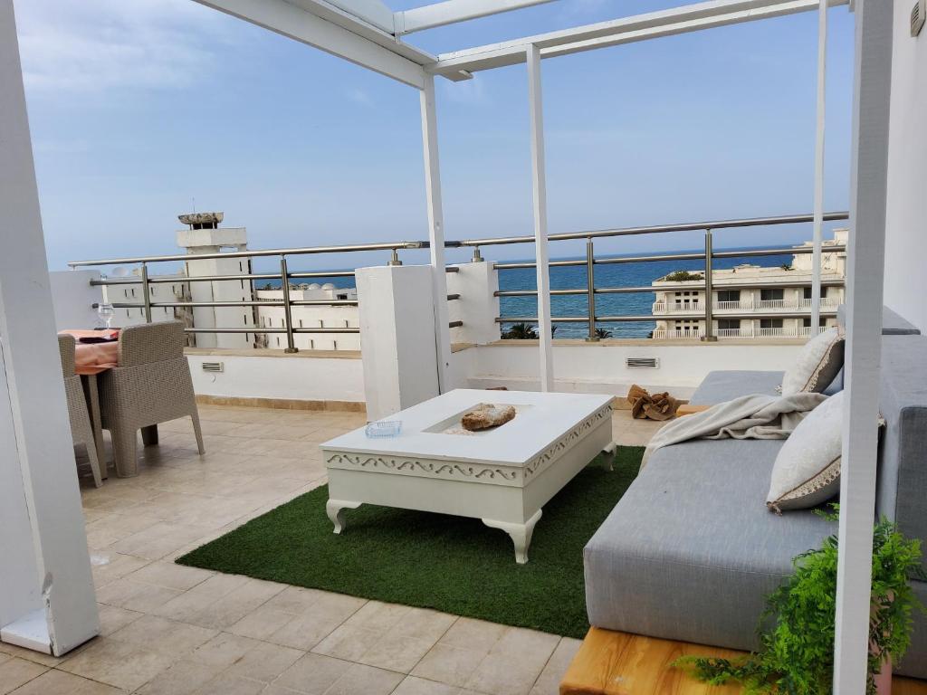苏塞Luxury penthouse in Sousse的船上的阳台配有沙发和桌子