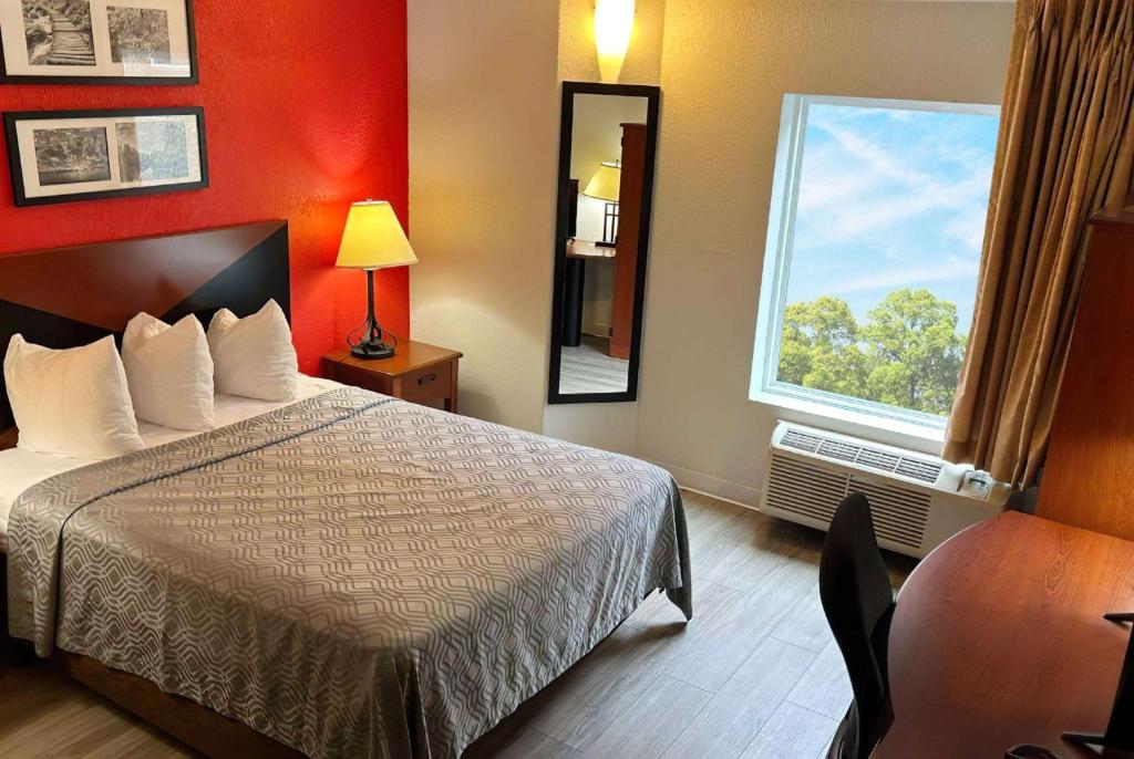 尚佩恩Howard Johnson by Wyndham Urbana的酒店客房设有床和窗户。