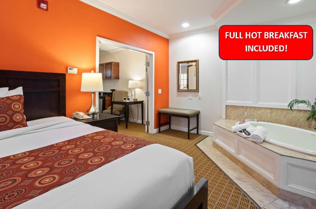 西奥兰治威尔希尔格兰德酒店的酒店客房配有一张床和浴缸。