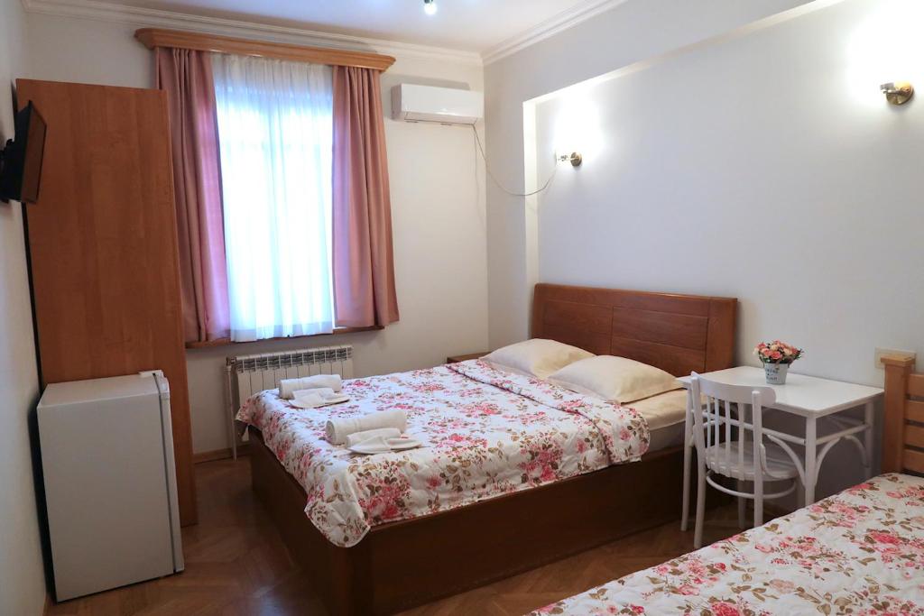 第比利斯guest house Merci的一间小卧室,配有两张床和窗户