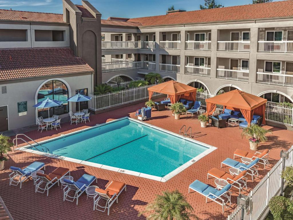 米尔布雷旧金山西机场拉奎因塔酒店的享有酒店游泳池的空中景致,配有椅子和遮阳伞