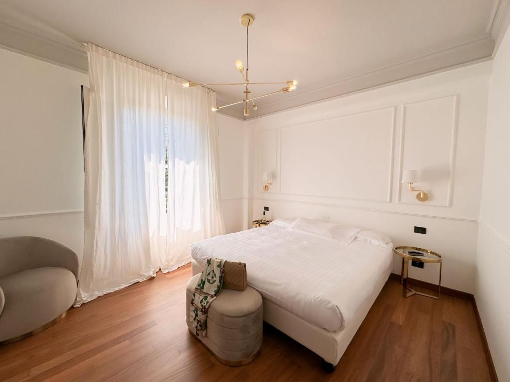 摩德纳雷齐吉公园酒店的白色卧室配有床和椅子
