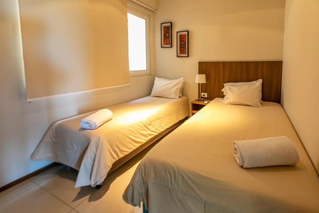 亚松森Asunción Rent Suites Santa Teresa的小型客房 - 带2张床和窗户