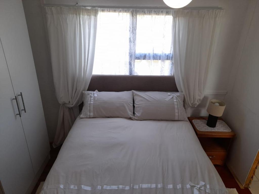 KamieskroonMegs Accommodation的卧室配有白色的床和窗户