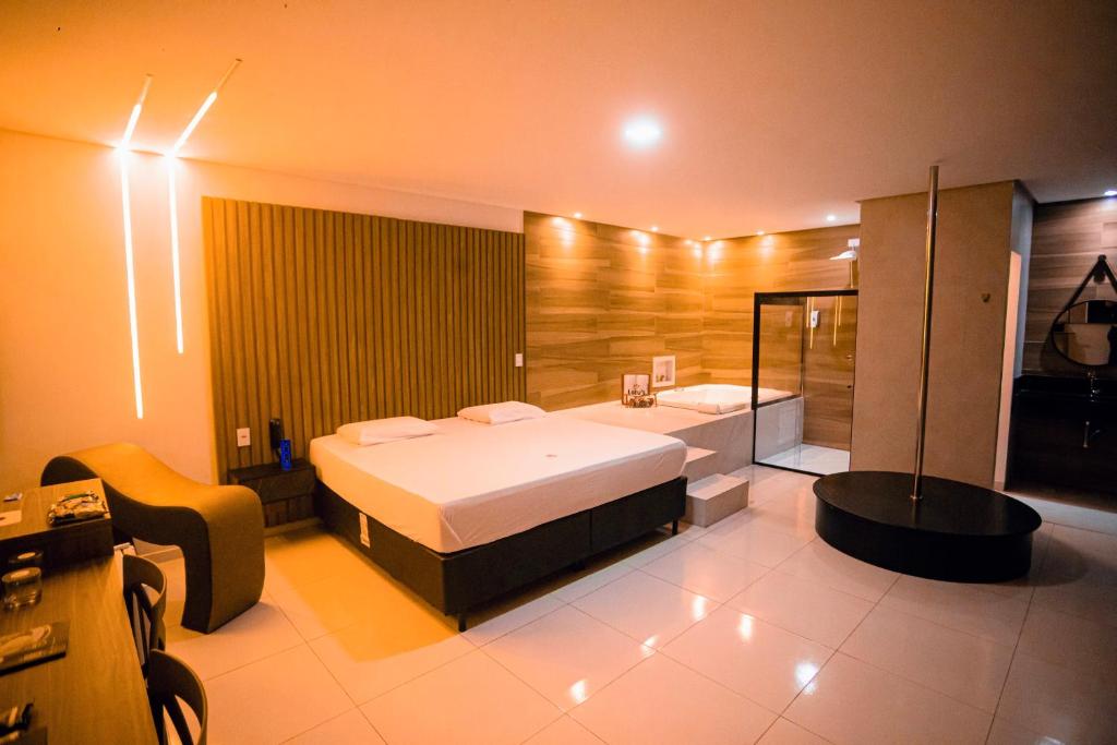 阿拉皮拉卡Lotus Motel Guaribas的一间卧室配有一张床和一个浴缸