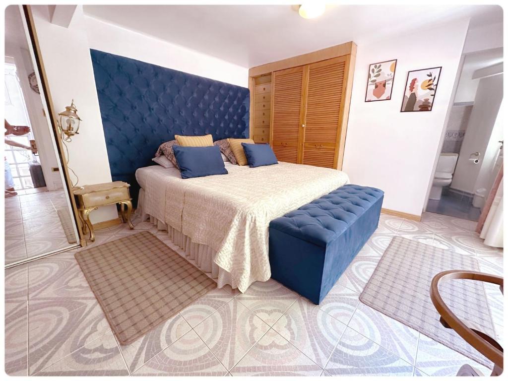 布宜诺斯艾利斯Apartamento loft Recoleta的一间卧室配有一张大床和蓝色床头板