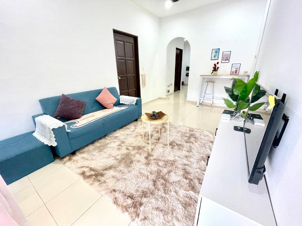 大山脚Cozy 288 Entire 3 bedroom House @ Alma Bukit Mertajam的客厅配有蓝色的沙发和桌子