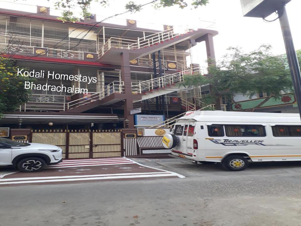 巴德拉恰拉姆Kodali Homestays的停在大楼前的白色巴士