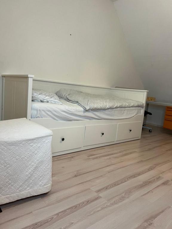 RednitzhembachFireApart的卧室配有白色的床,铺有木地板
