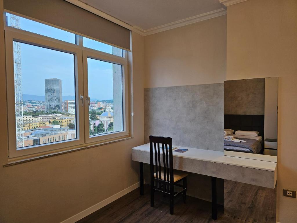 地拉那Sky Apartaments city center的客房设有书桌和窗户。