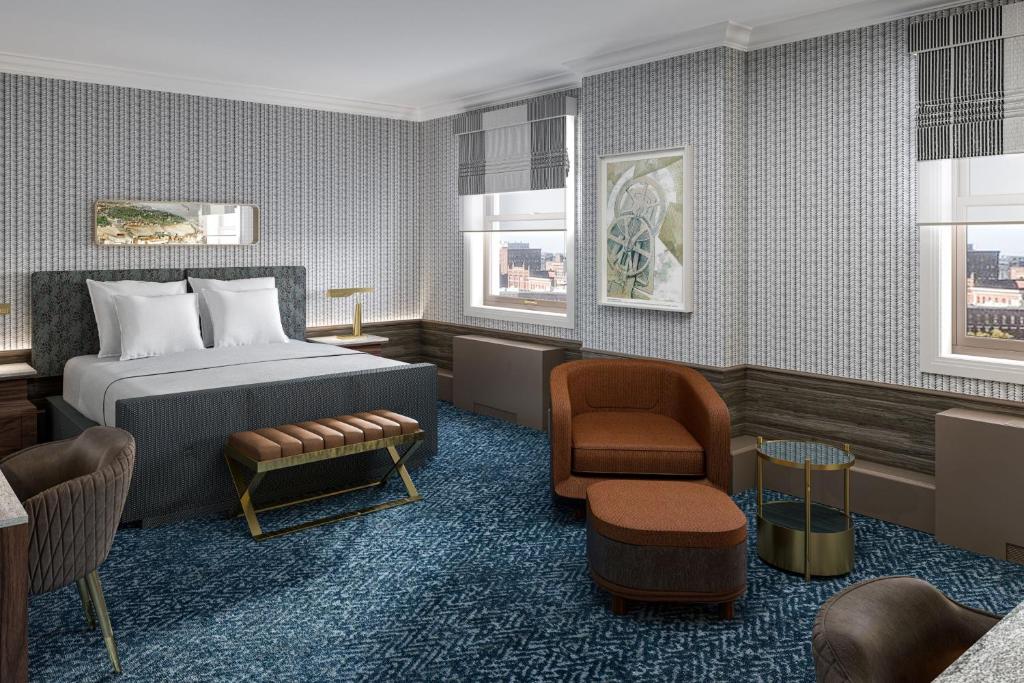 克利夫兰克利夫兰万丽酒店的配有一张床和一把椅子的酒店客房