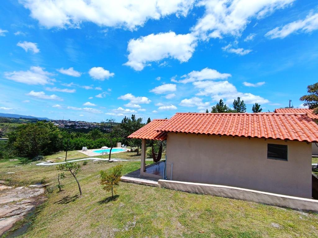 卡兰卡斯Toca dos Coelhos Chalés的一座红色屋顶的房子和一个游泳池