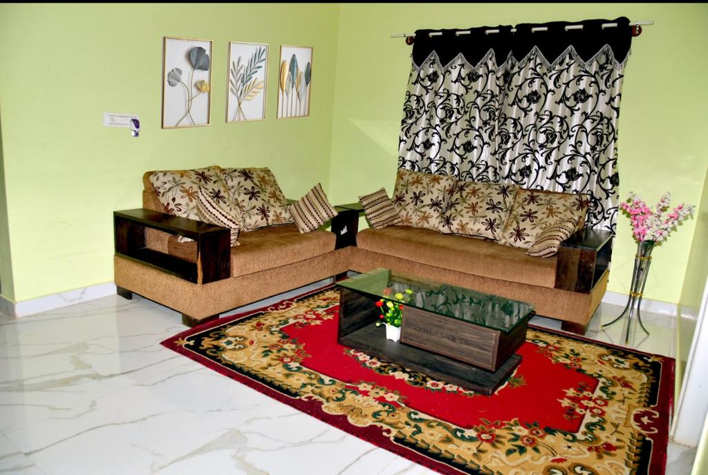 奇克马格尔Royal Guest House的客厅配有两张沙发和红色地毯