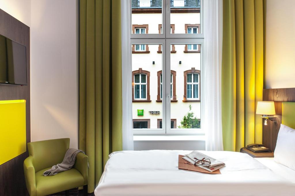 特里尔Ibis Styles Trier City的酒店客房设有床和窗户。