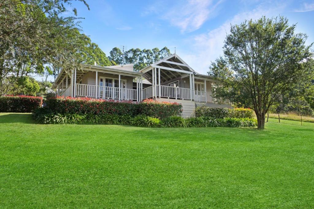 袋鼠谷Wild Rose Cottage Kiaroo Estate, Kangaroo Valley的一座带绿草大院子的房子