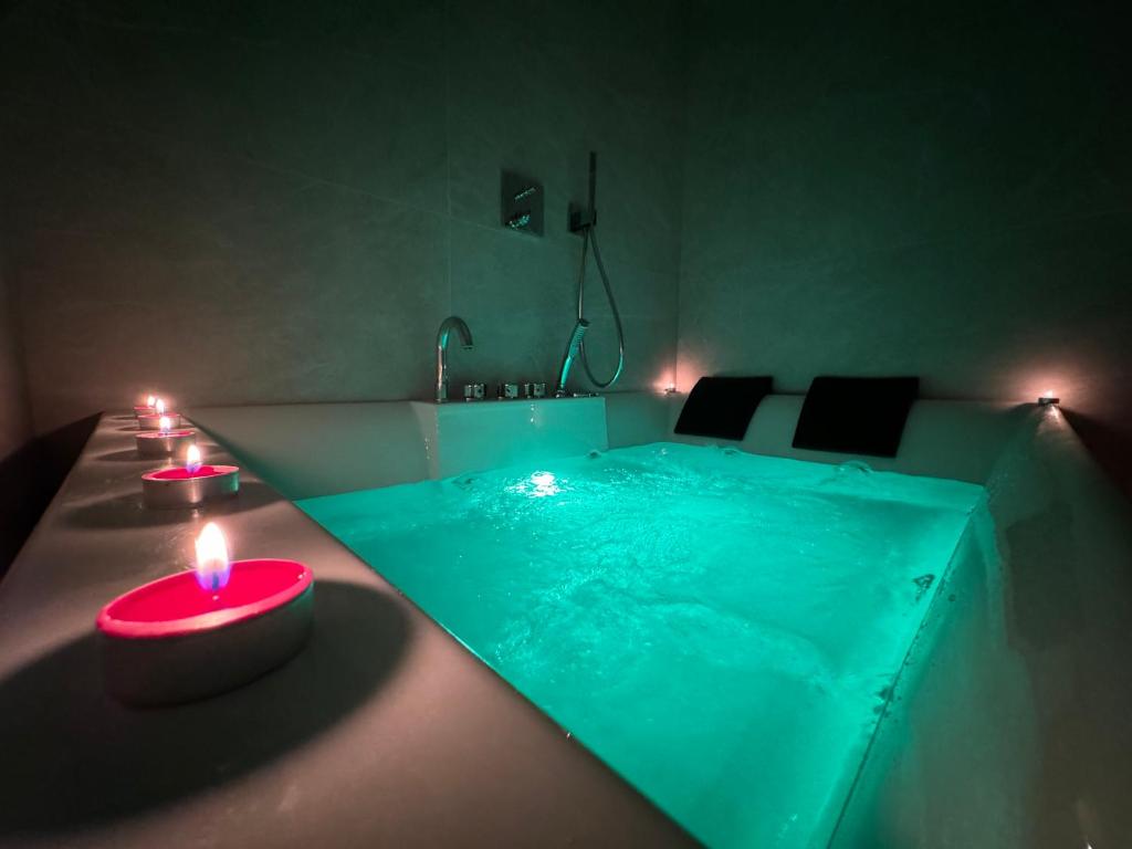 米兰MEG Glamour Suite的一间设有游泳池的房间,配有两个烛光蜡烛