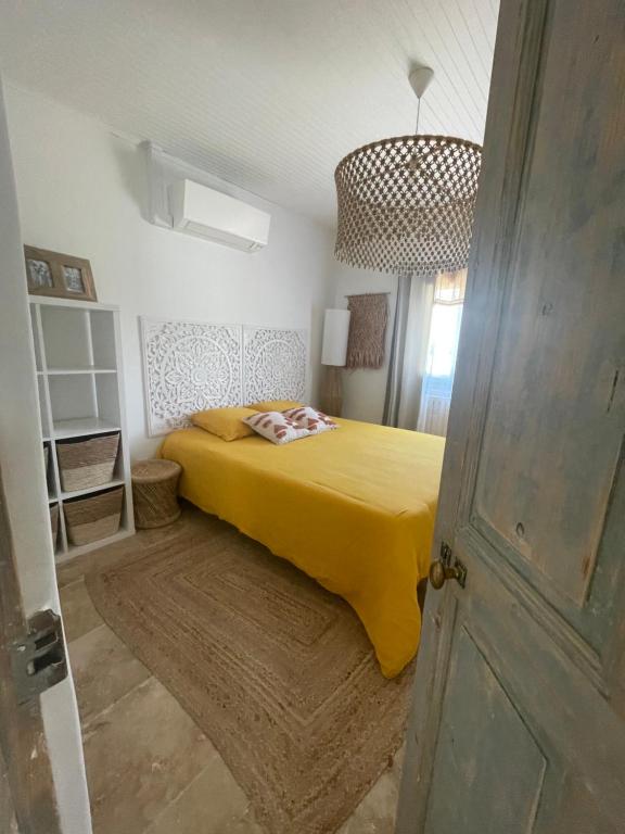 卡瓦永Entre les Alpilles et le Luberon 3 chambres 10 pers的一间卧室配有一张黄色毯子床