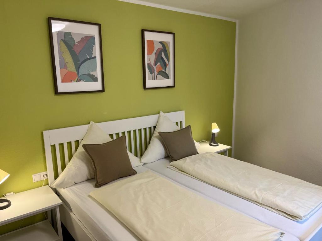 安德纳赫Gasthaus Stammbaum的一间卧室设有两张带绿色墙壁的床