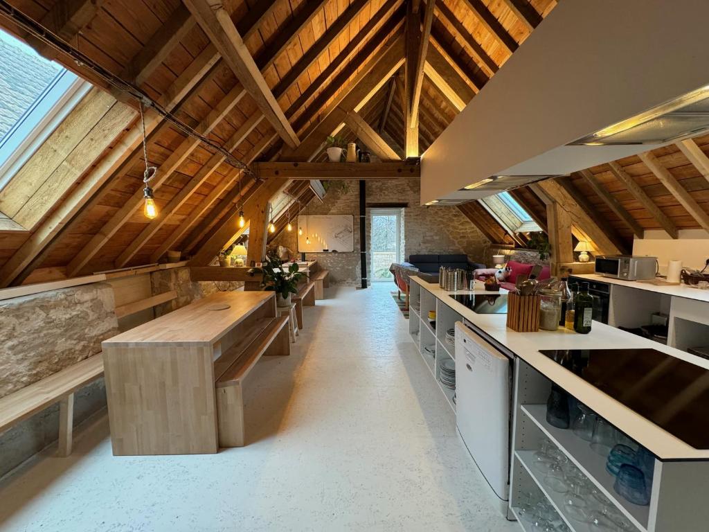 滨海利翁LES BRIQUES的大型厨房设有木制天花板和木制柜台。