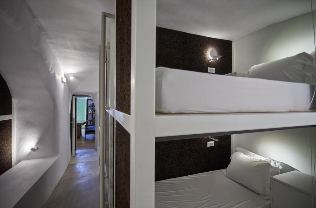 伊亚Hostel 16 Oia的带两张双层床的客房和走廊
