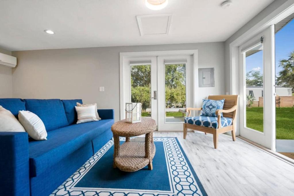 圣奥古斯丁Coral Cottage, Stylish Studio Suite on Canal, Walkable to Beach, Private Parking的客厅配有蓝色的沙发和椅子