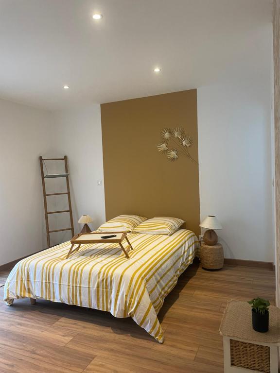 圣迪济耶La Suite en Or的一间卧室配有一张带黄色条纹棉被的床