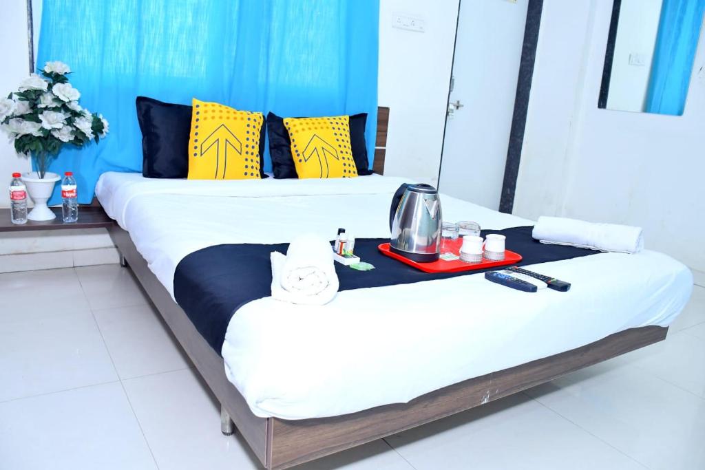 浦那Hotel Pristine,Pune的一张位于酒店客房内的两张床,配有一个食品托盘