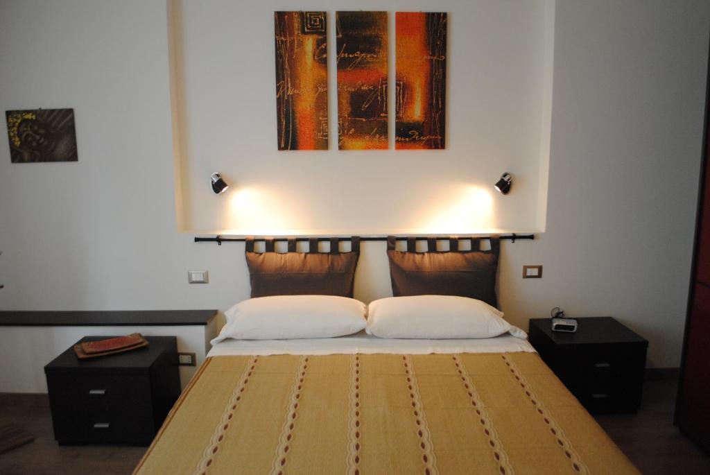 佛罗伦萨Casa Gordigiani - bilocali con parcheggio的一间卧室配有带两个枕头的床和一幅画