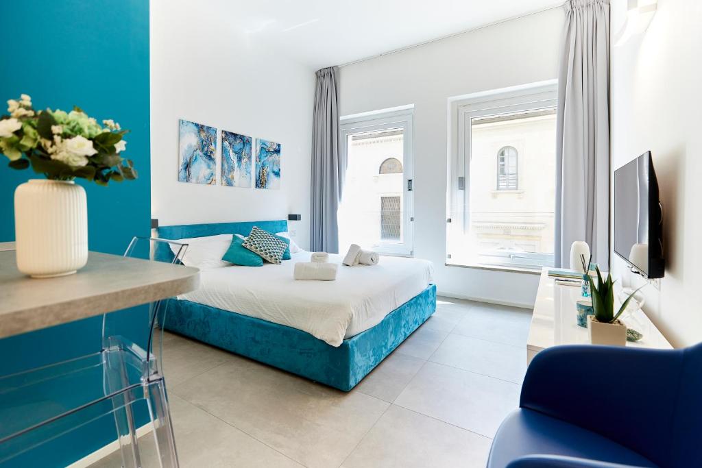 米兰Suite Meravigli - Incredibile posizione DUOMO e CASTELLO的蓝色和白色的卧室设有1张床和1台电视