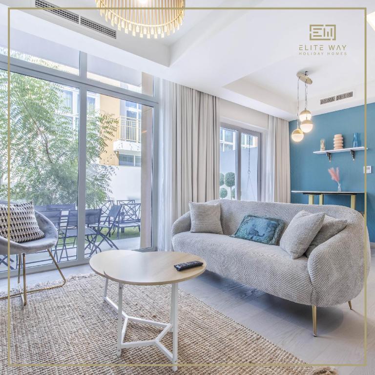 迪拜Impressive 3BR Villa-Akoya的客厅配有沙发和桌子