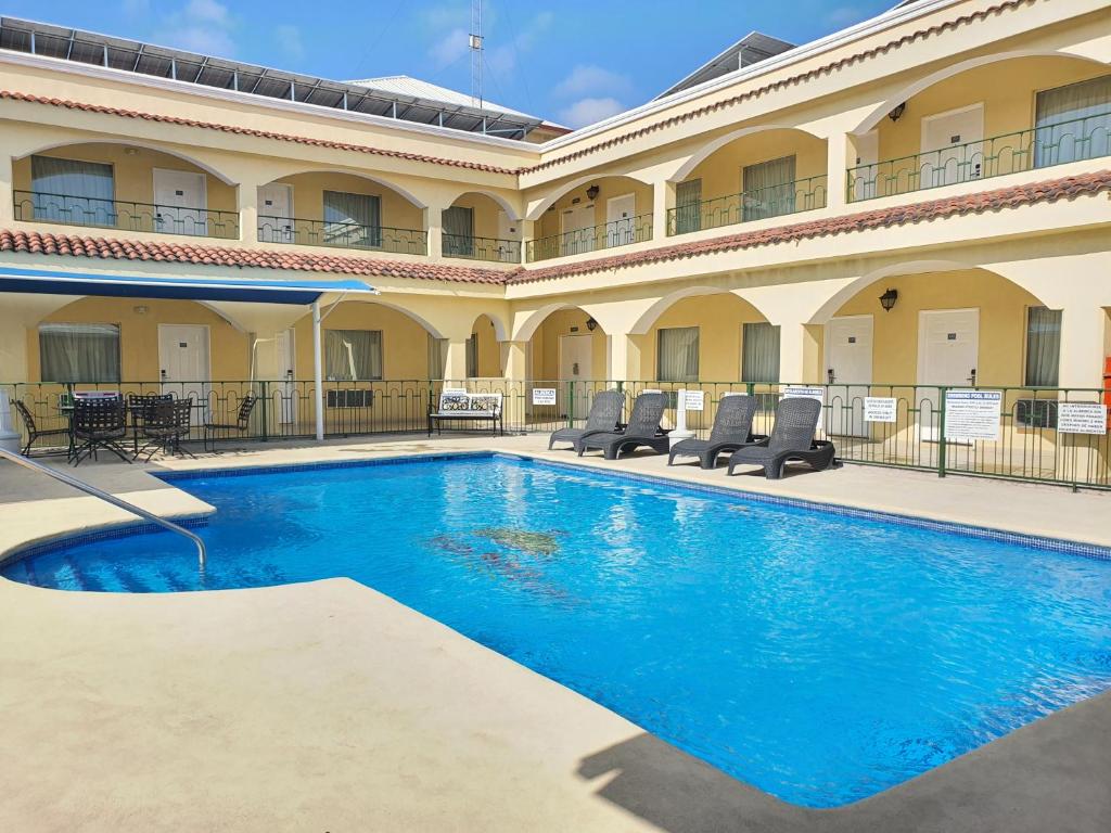 蒙克洛瓦Hotel Las Misiones的一座大建筑前的游泳池