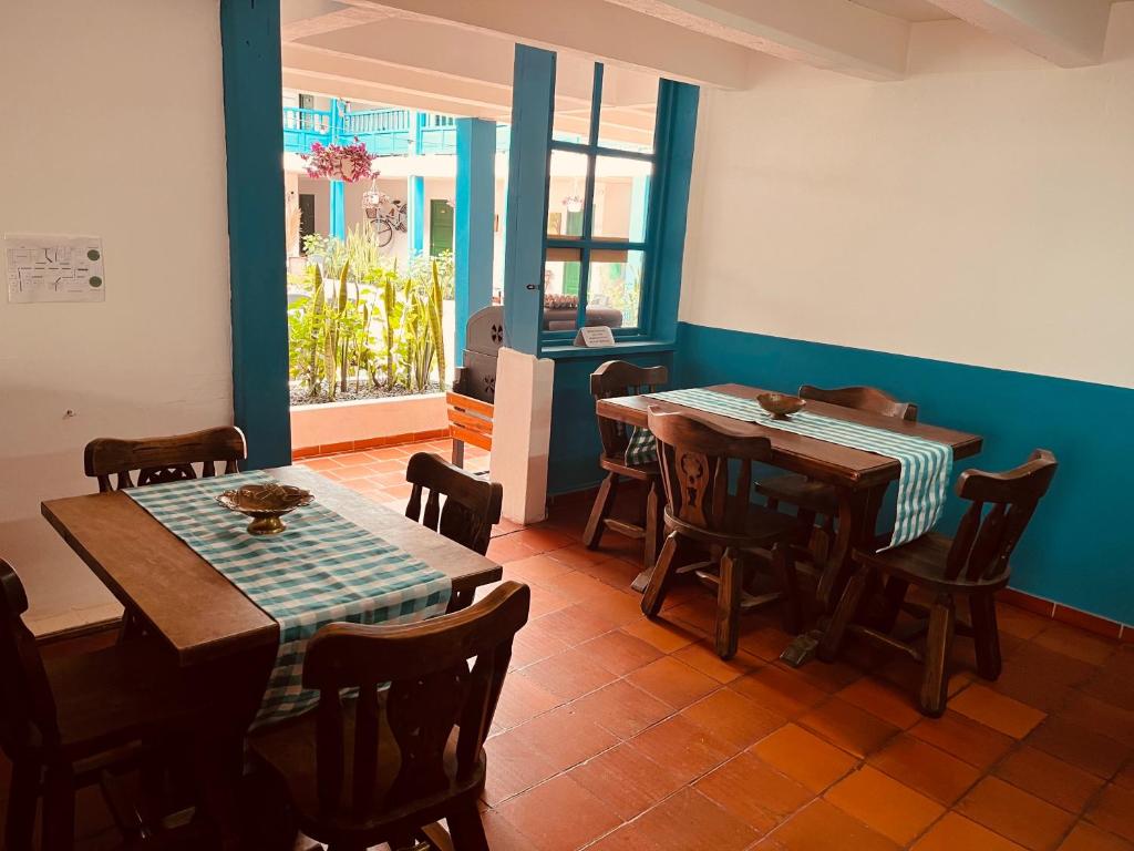 莱瓦镇Celeste Villa de Leyva的一间带2张桌子和椅子的用餐室