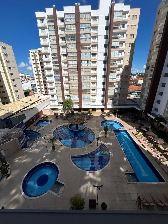 阿西斯Caldas Novas - Condominio Casa da Madeira - ate 5 pessoas - PERMITIDO descer com bebida para o parque - Centro的享有带2个游泳池的大型建筑的顶部景色