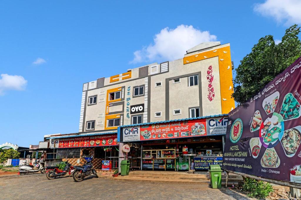 OngoleSPOT ON Hotel Maha Lakshmi的前面有商店的建筑