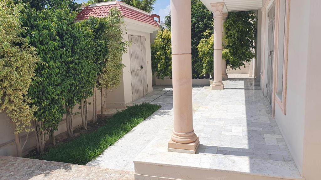 哈马马特Villa Sérénité, Yasmine Hammamet的房屋的空走廊,有柱子
