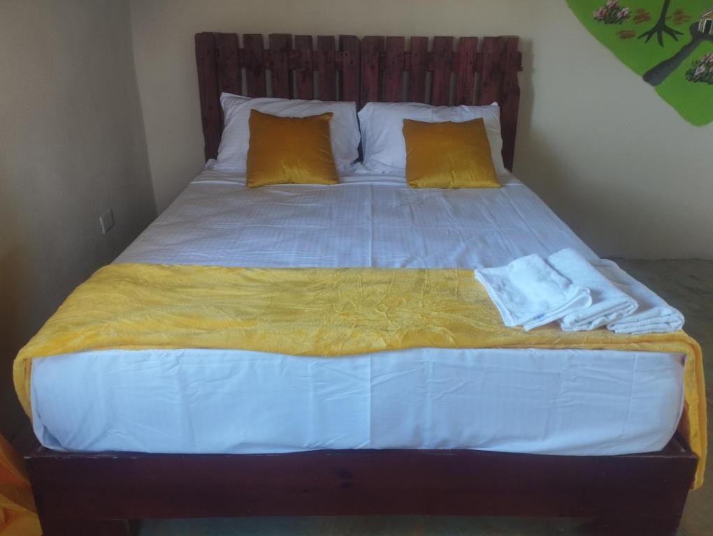 拉斯加勒拉斯Cabañas Raysa y Alejandro Pasion #3的一张带黄色枕头和蓝色毯子的床