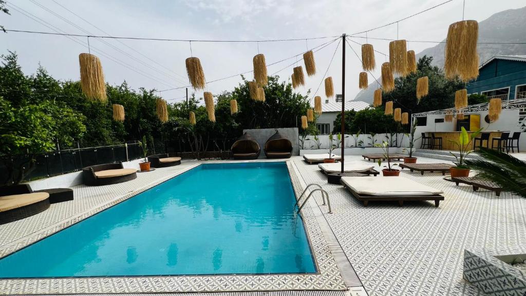 安塔利亚GÜLER BUTİK HOTEL的一个带躺椅的游泳池,一个度假村