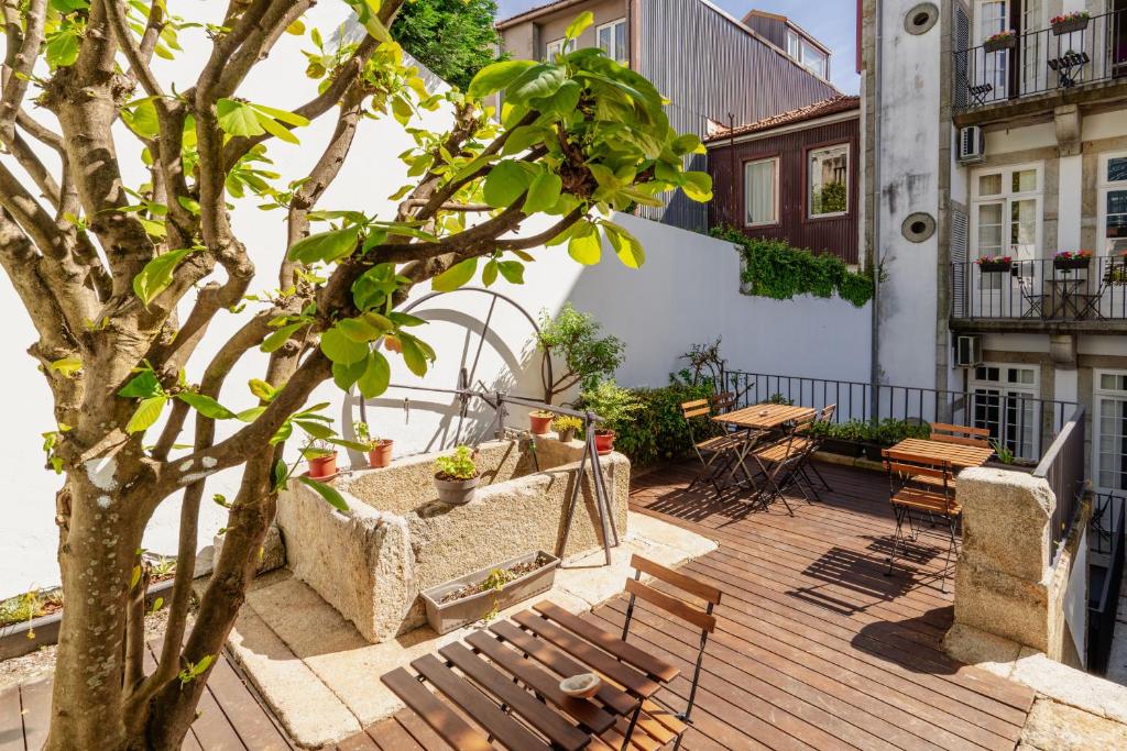 波尔图Porto Lounge Hostel & Guesthouse by Host Wise的木甲板上设有长椅和树