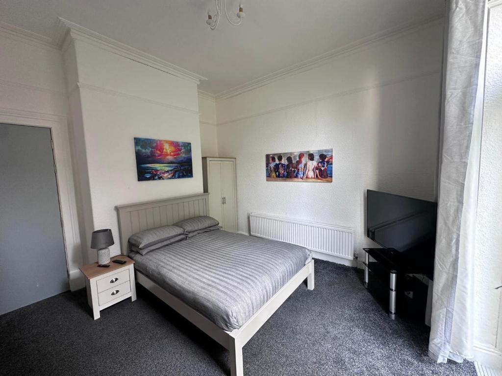 Rock Ferry@22的一间卧室配有一张床和一台平面电视