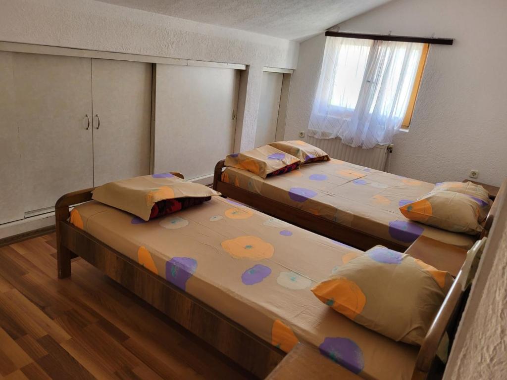 斯特鲁加Vreshtat e Liqenit-Ezerski Llozja的一间卧室设有两张床和窗户。