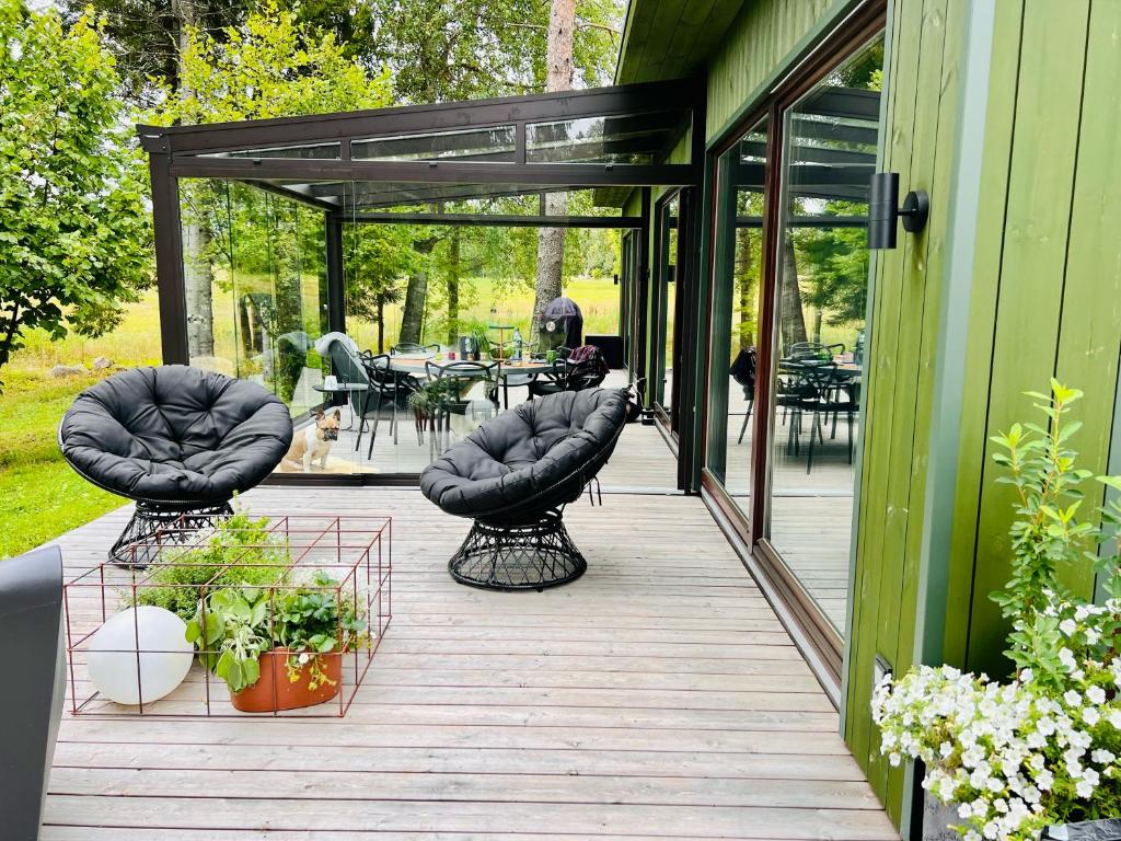 AiasteHouse and sauna where city comforts meet nature的一个带桌椅的门廊和庭院