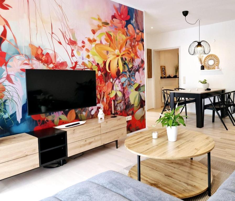 GammelsbachFerienwohnungen Krüger 'Apartment Marina'的客厅配有大电视和色彩缤纷的墙壁
