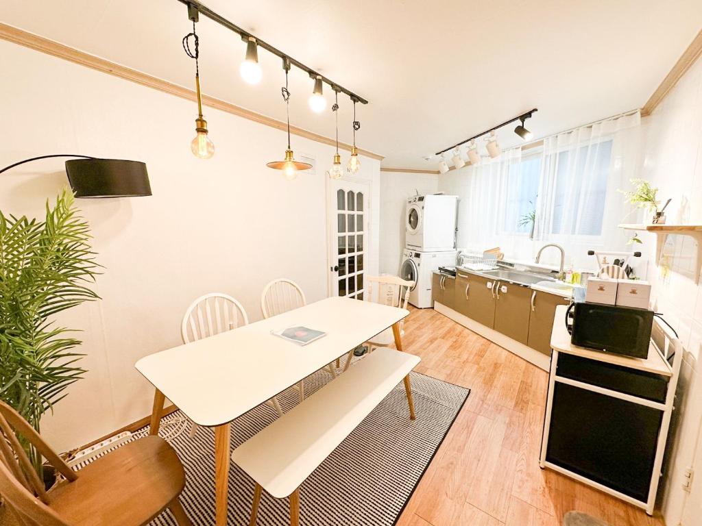 首尔STAY ROCK 樂 2 Room 3 Beds 3 min from Ewha Univ stn的厨房以及带桌椅的用餐室。