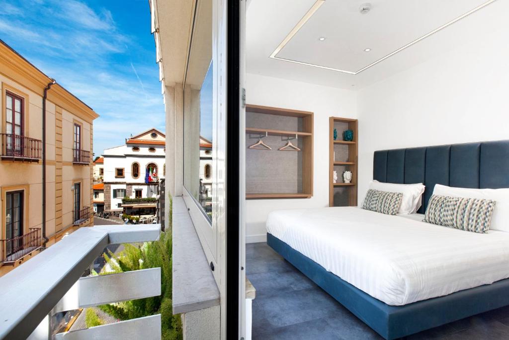 索伦托Hotel Tasso Suites & Spa的阳台卧室(带一张床)